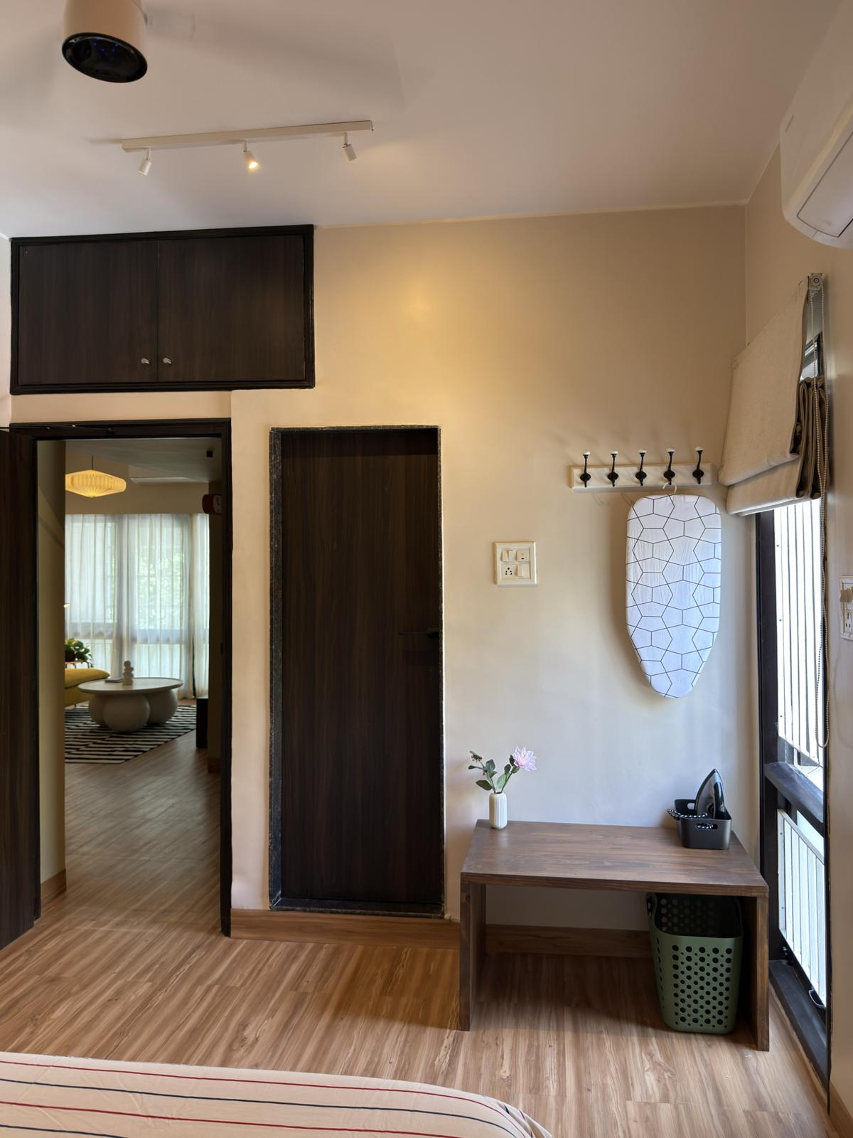 View from a bedroom through a doorway into the bright living room